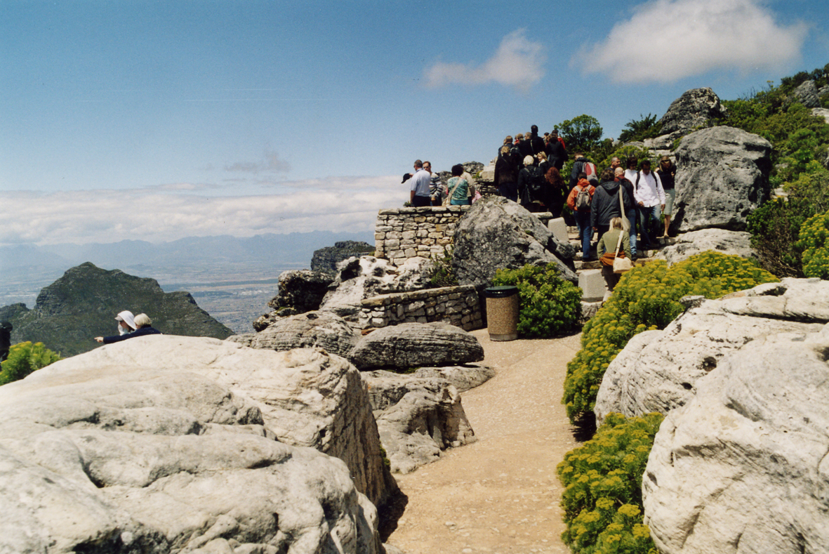 Taffelberget. Stier med fast dekke av betong og utsiktsplasser på kanten av stupet styrer trafikken og skjermer naturmiljøet mot nedtråkking og skade. Taffelberget. Stier med fast dekke av betong og utsiktsplasser på kanten av stupet styrer trafikken og skjermer naturmiljøet mot nedtråkking og skade.